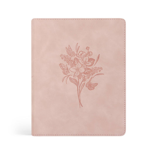 Pink bible with floral design on a white background